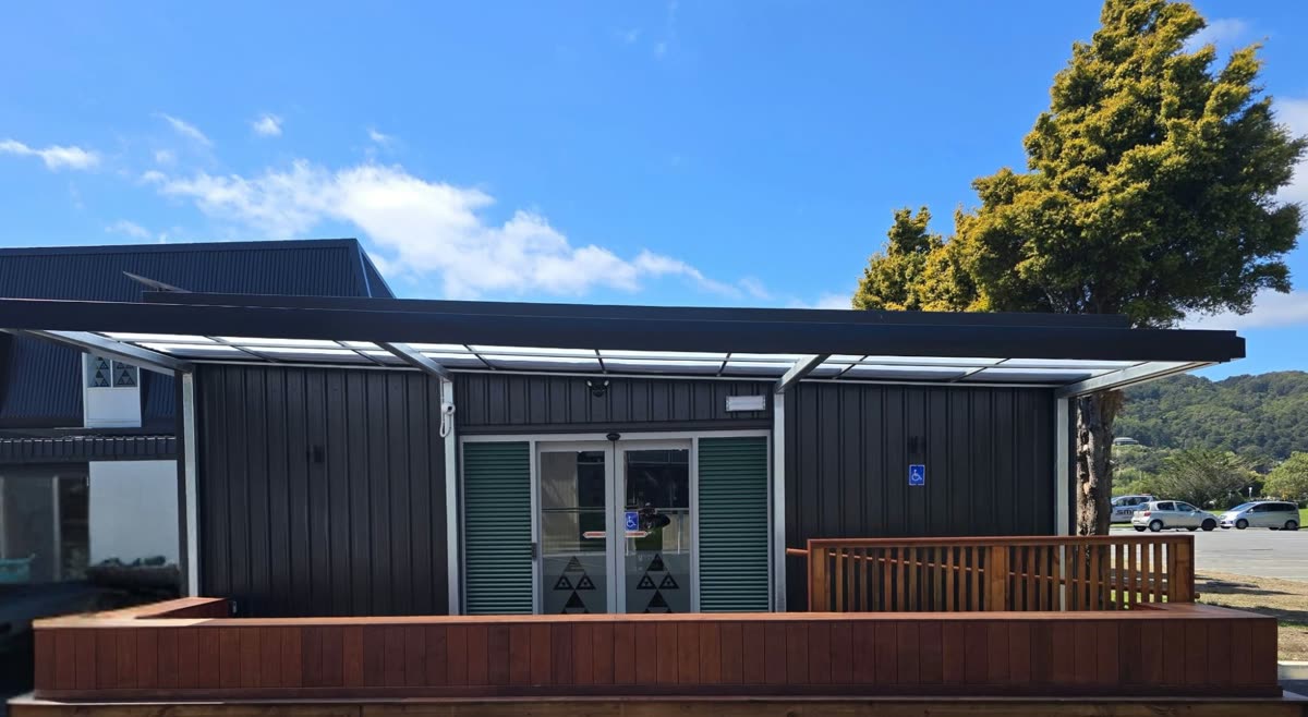 The Waiwaka laundromat building, with its timber deck and covered entrance